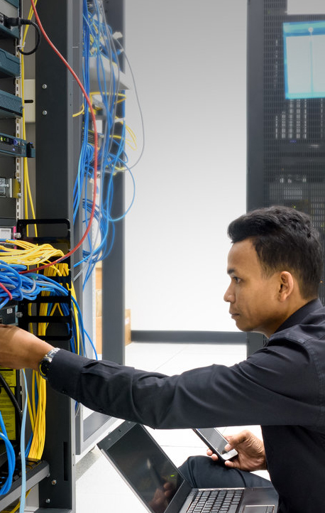 Network engineer working in server rack